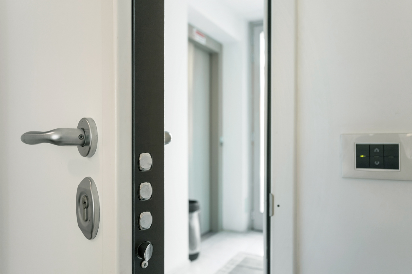Locksmith installing modern lock on Canadian door