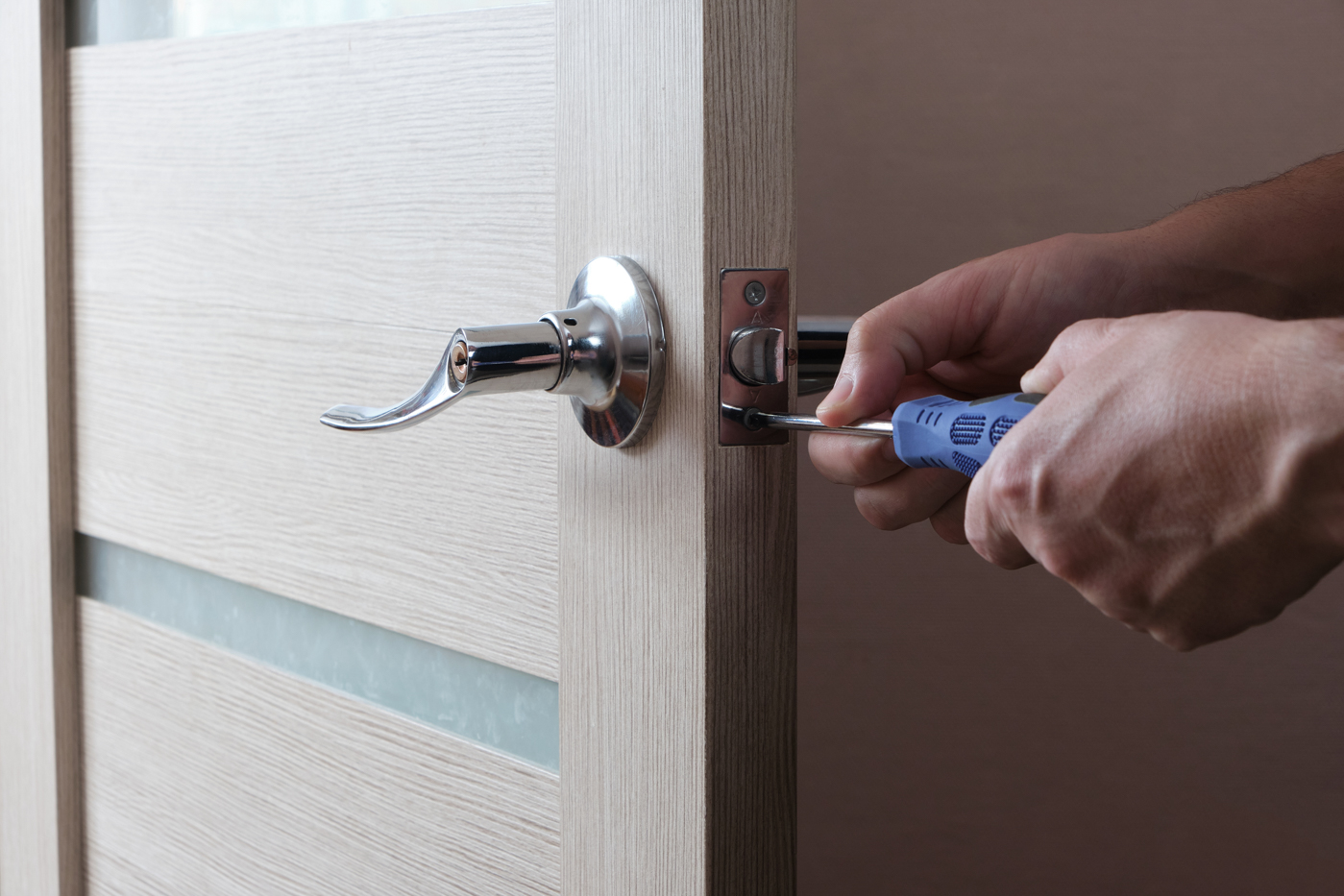 Locksmith installing deadbolt lock on new build door