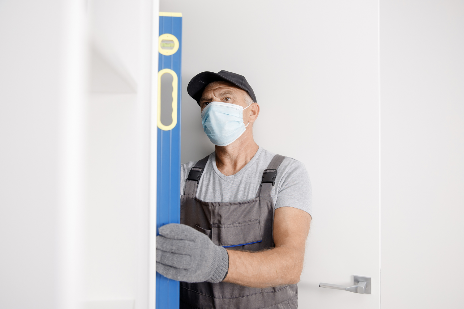 Door repair technician levelling interior door
