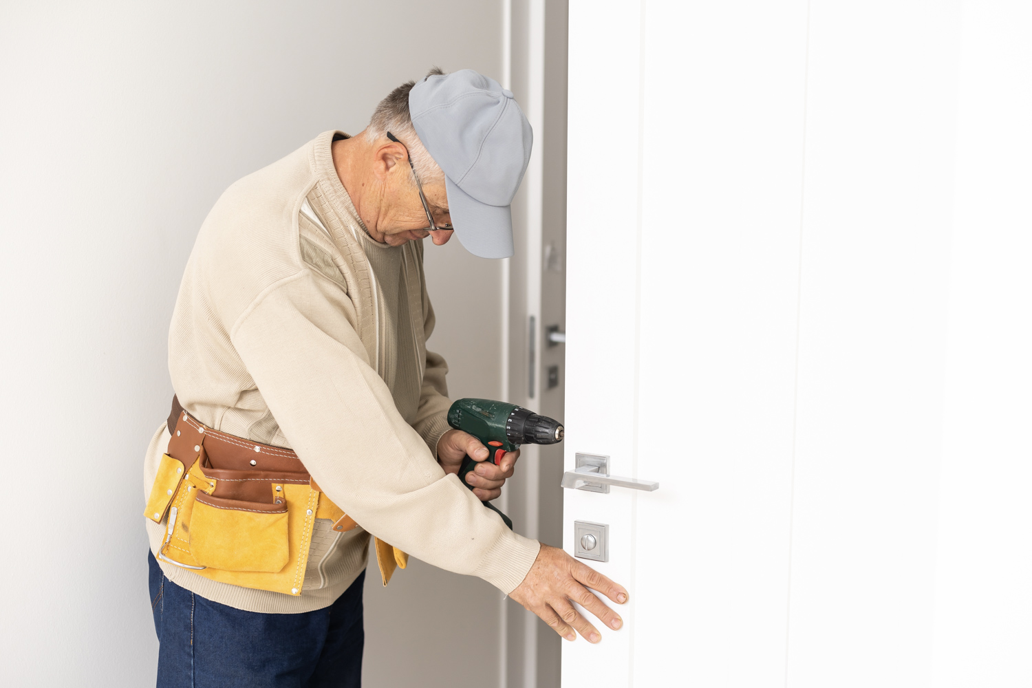 Door installation with drill in Canadian home